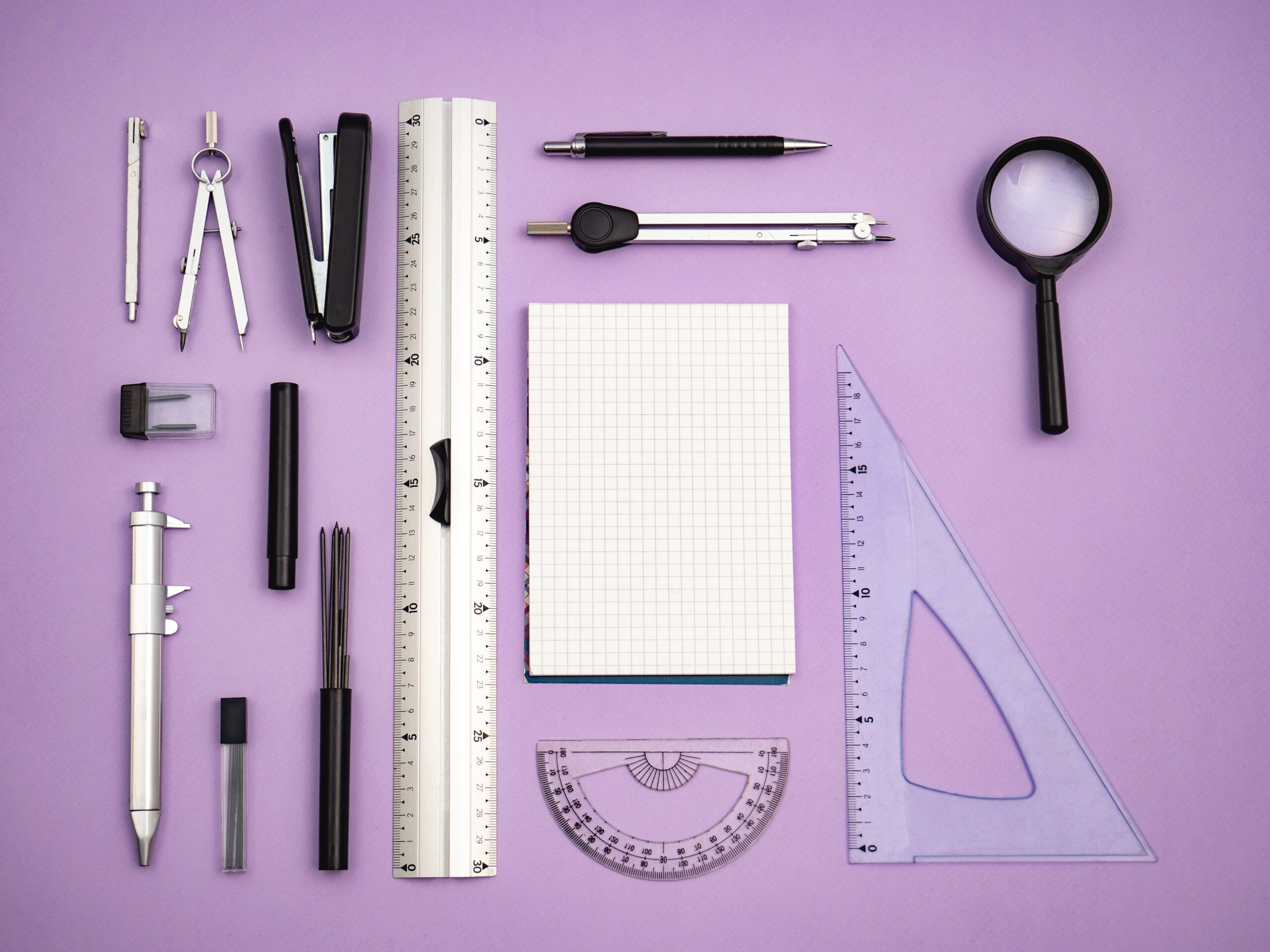 Various measuring tools with a purple background.